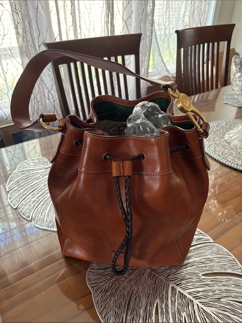 A Dooney and Bourke Brown Italian Leather Drawstring Bucket Bag.